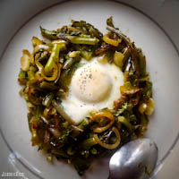 Kale stems and onions with baked egg